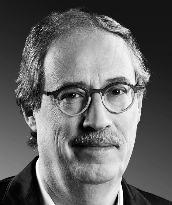 Black-and-white portrait photograph of a man wearing glasses